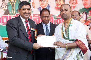 EO Presenting certificate of appreciation to Sri Gururaja Rao Bokkasam Clerk