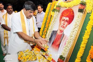eo paying floral tribute to the portrait of Mahatma Jyotirao Phule