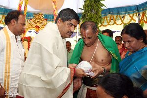 governor receiving swamy vari prasadam from eo